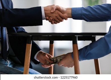 businessman-taking-bribe-man-under-260nw-1225177960.jpg