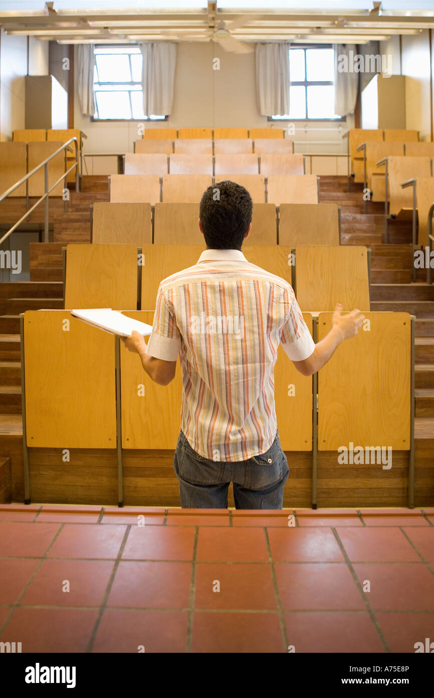 student-speaking-before-empty-classroom-A75E8P.jpg