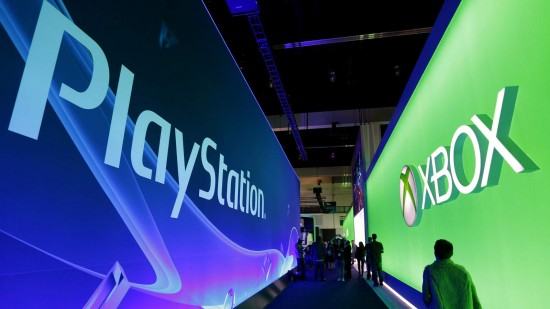 People walk past the Playstation and Xbox booths at the 2014 Electronic Entertainment Expo, known as E3, in Los Angeles